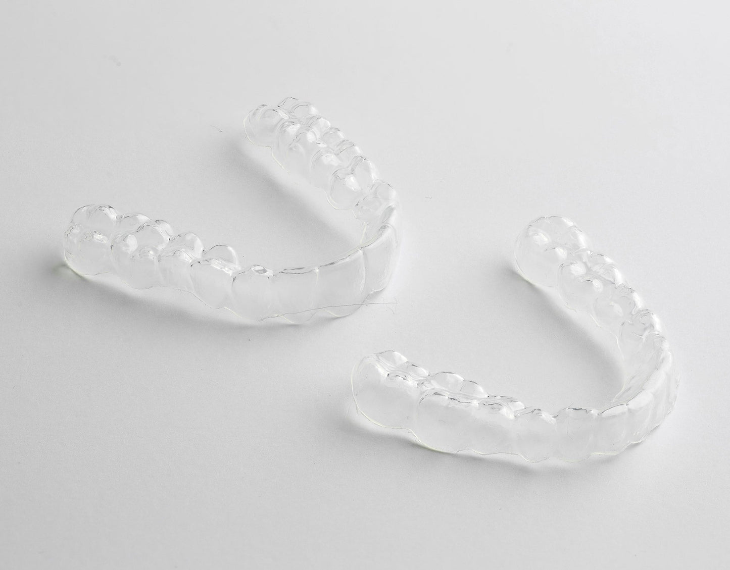 Two Custom Clear Retainers showcased on a white background, emphasizing their clear, durable design, best retainers for after-braces dental care - Snap Custom Nightguards