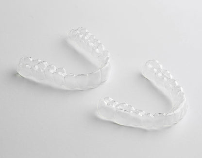 Two Custom Clear Retainers showcased on a white background, emphasizing their clear, durable design, best retainers for after-braces dental care - Snap Custom Nightguards