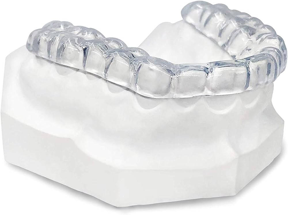 Snap Custom Daytime Teeth Grinding Guard displayed on a dental mold, illustrating its precise and discreet design for daytime wear. Similar in construction to the trusted nightguard but optimized for a more inconspicuous look, this clear dental guard offers protection against daytime teeth grinding without drawing attention. The image focuses on the guard's snug fit and transparency, making it an ideal choice for those seeking a subtle solution to bruxism during their daily routine.